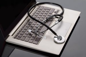 Medical Stethoscope Over Laptop